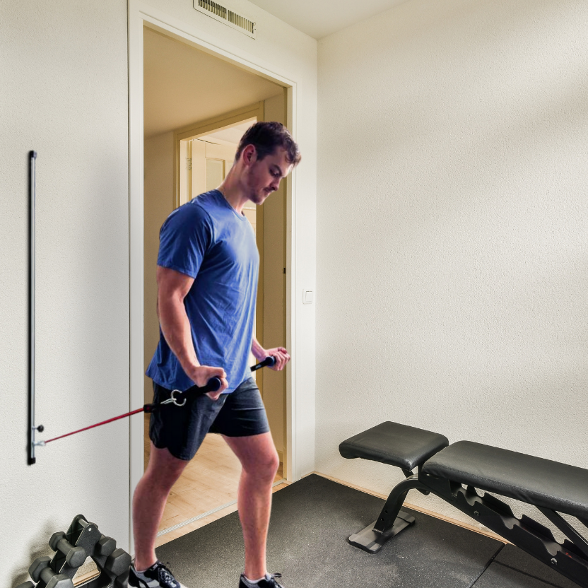 Male user is performing bicep curls with resistance band wall mount.